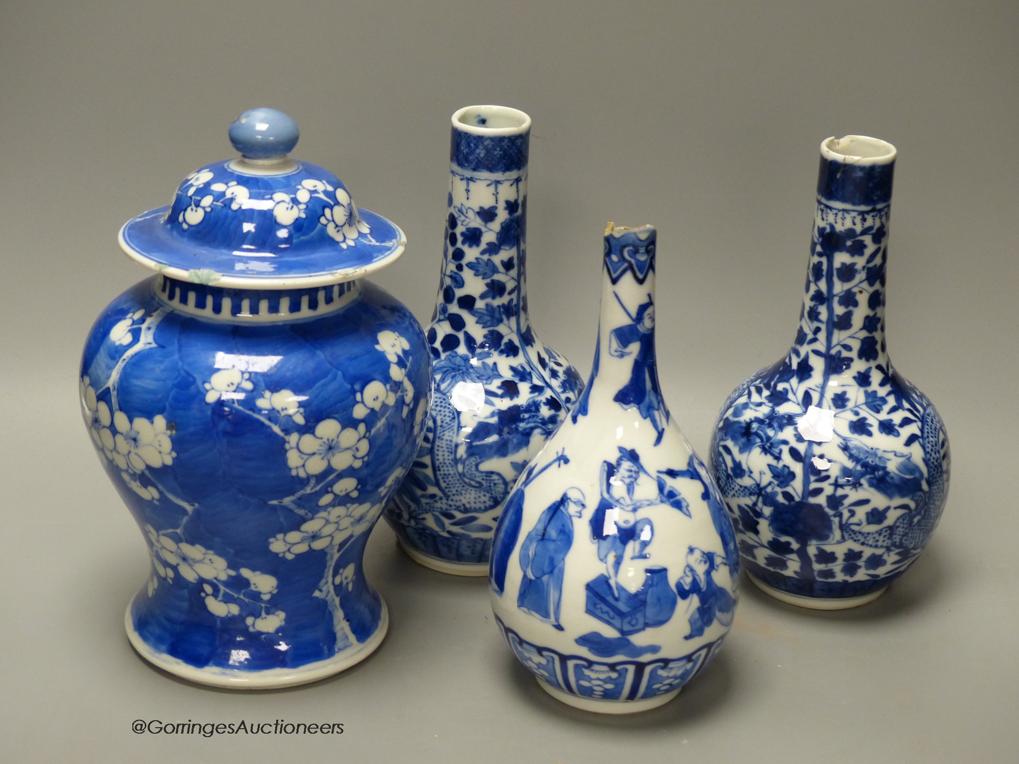 A pair of Chinese blue and white 'dragon' bottle vases, a prunus jar and cover, all late 19th century